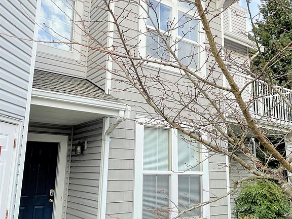 Front door view. Ground floor unit with private patio and outdoor green space surrounding the front and sides.