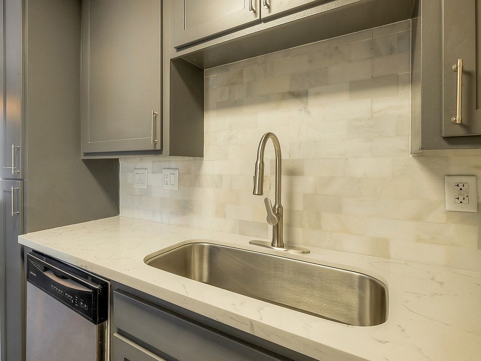 New gray cabinets, white quartz counter top and ceramic tile back splash
