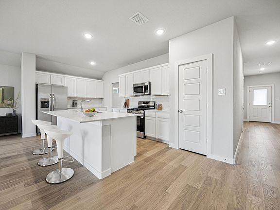 Kitchen in the Harrison home plan by Trophy Signature Homes - REPRESENTATIVE PHOTO