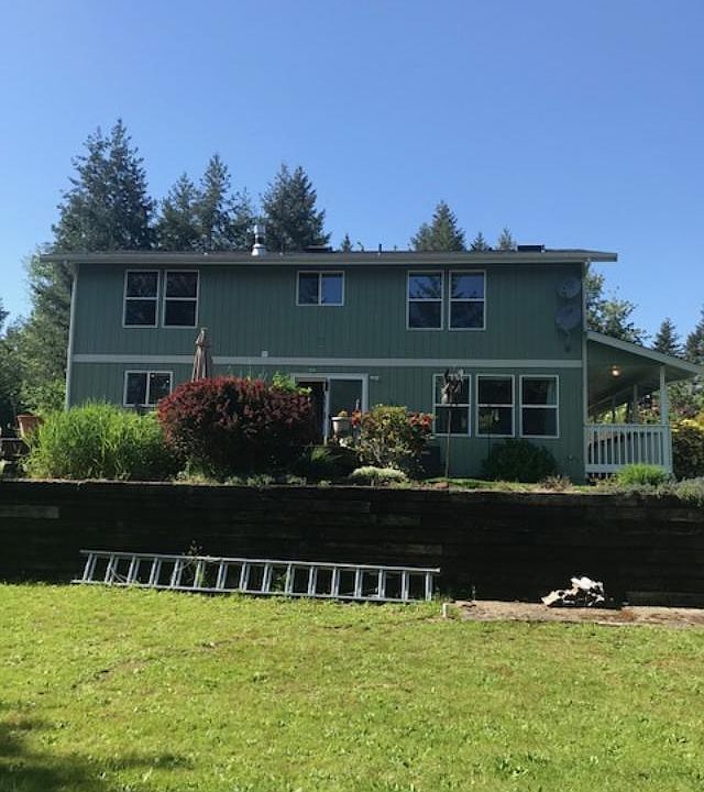 Back of home with large deck