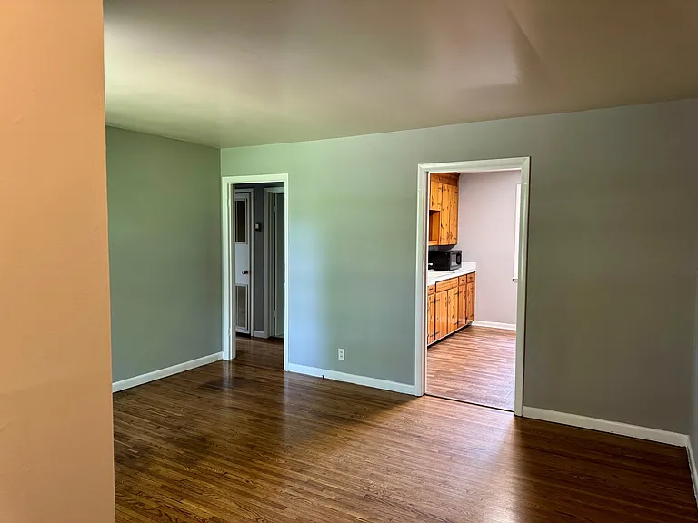 Living room entrance to kitchen and hallway.
