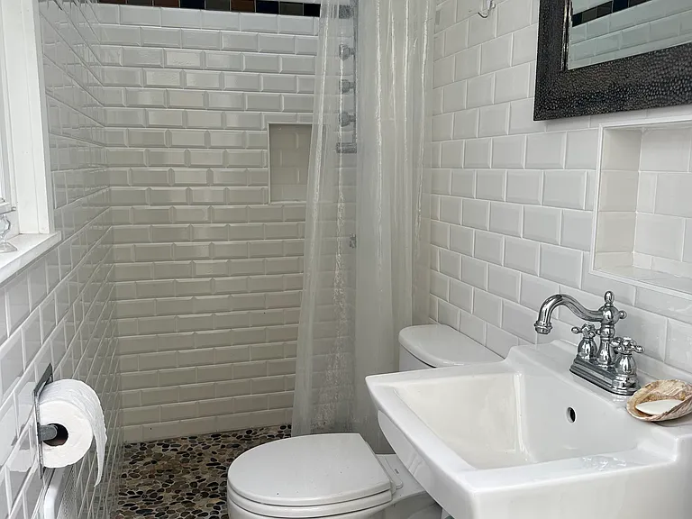 Full outdoor bathroom with skylight and window