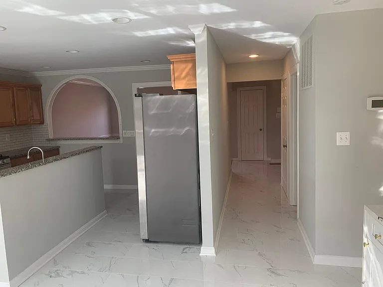 Main level Hallway from Kitchen to the Foyer. Powder Room on the right