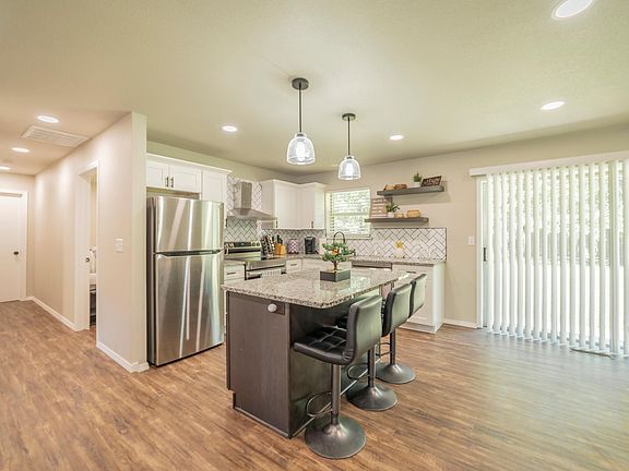 Ample light with sliding glass doors into the spacious backyard