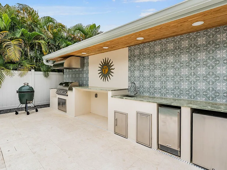 Outdoor Kitchen contains a BBQ and outdoor frig.