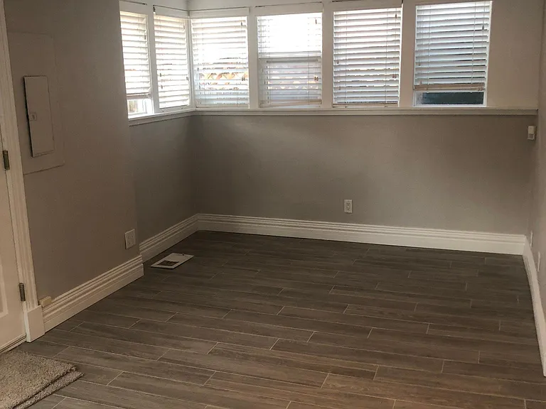 Sunroom looking east. Heated tiled floors