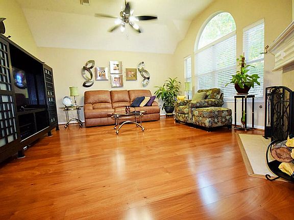 Large living room with wood floors & a beautiful gas log fireplace.
