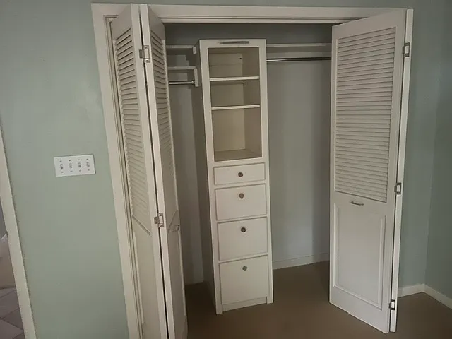 Master bedroom. Folding closets with build in shelves.
