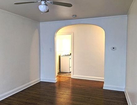 Living room looking toward entrance hallway and lighted kitchen