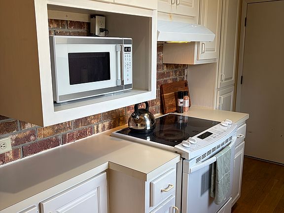 Kitchen with microwave and electric stove