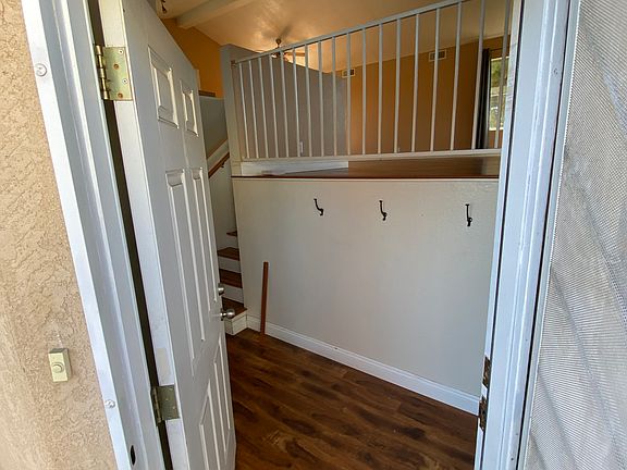 Front entry. Stairs to the right go up to spacious, open-floor kitchen/dining/living area.