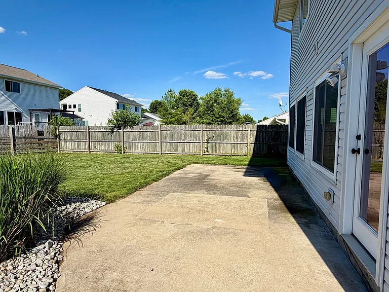 Fully fenced rear yard with large concrete patio and fire-pit, for peaceful and pleasant evening at home