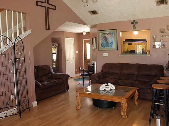 Gorgeous, open concept family room with bamboo wood flooring, ceiling fan, and window to study.