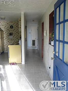 Entrance from front porch into dining room. New tile just laid down! Also, freshly painted front and side entrance doors.