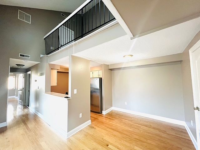 Living room with high ceiling and skylight with loft.
