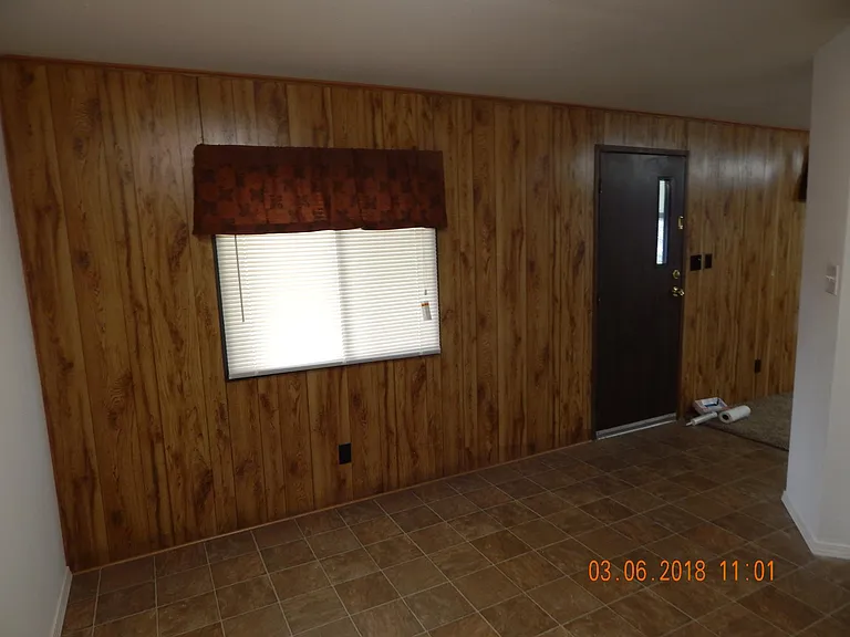 Looking at window from kitchen with front entrance at right.