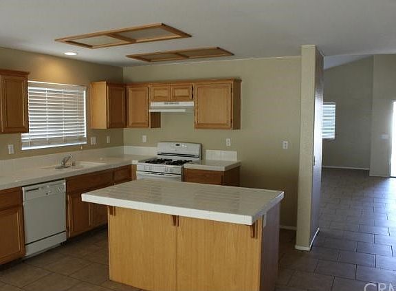 Kitchen is Open and Bright.  New flooring and new window blinds