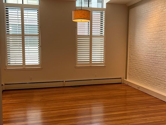 Living Room with refinished wood floors and track lighting.