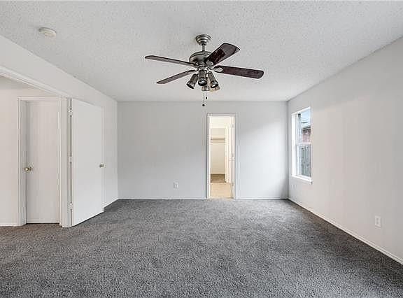 Coming from the front living room and formal dining room, you have french doors leading into this huge master bedroom with plenty of room for a king size bed and a sitting area that also features the master bathroom (straight back) and a huge walk in clos