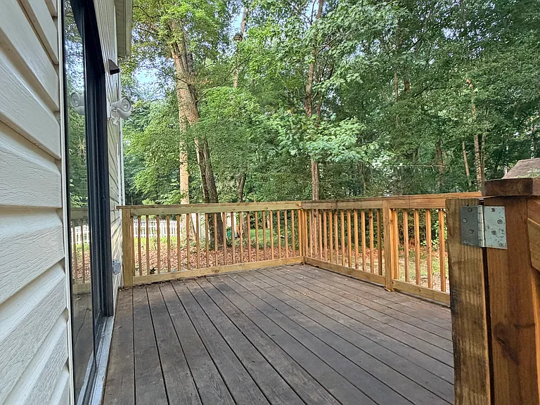 Private back deck, right off of kitchen, overlooking property