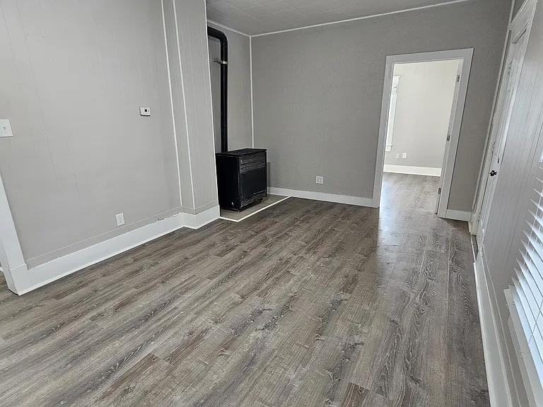 Big Living room 16' 6" x 10' 6" with Natural gas heat looking towards front bedroom