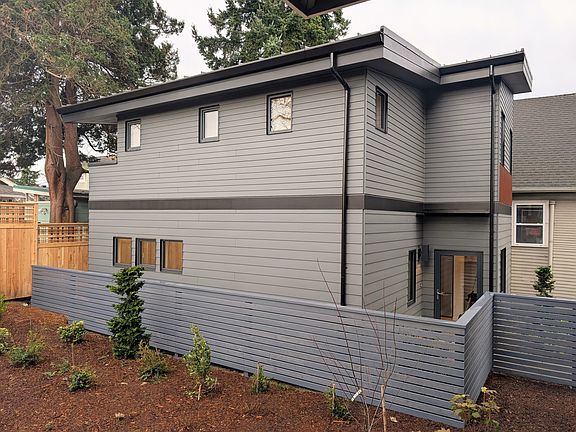 East side with fenced yard.