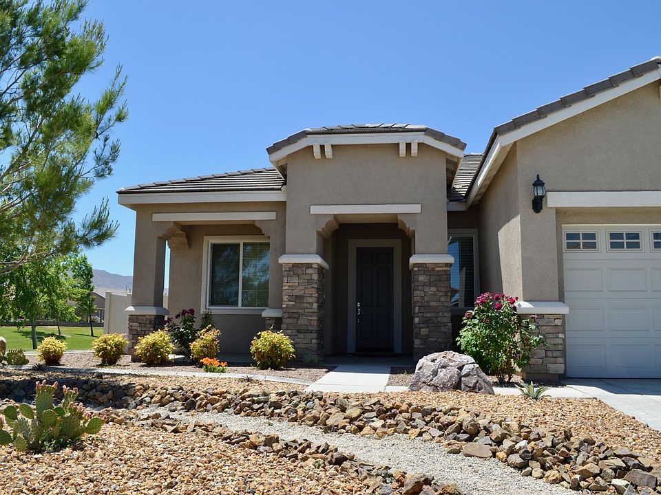Exterior view from Street. Golf Course passes by East side of home