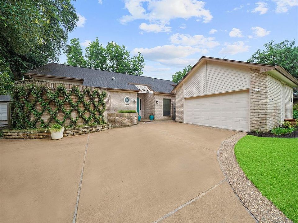 This charming 2/2/2 brick home (w/ study and sunroom) sits back from the street with a pretty, lush lawn and manicured garden beds. A wide driveway curves in front of the house and leads to the oversized 2 car garage. The driveway offers both homeown