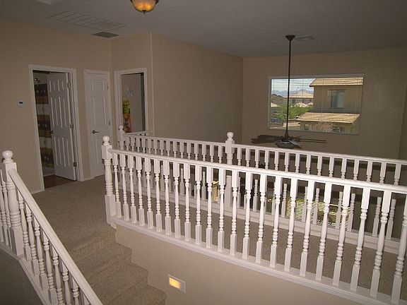 Beautiful upgraded wood railing at stairs, balcony overlooking Great Room