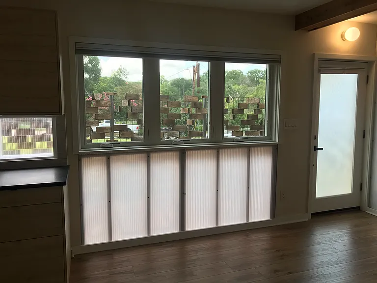 Shoal Creek pedestrian bridge visible from large window