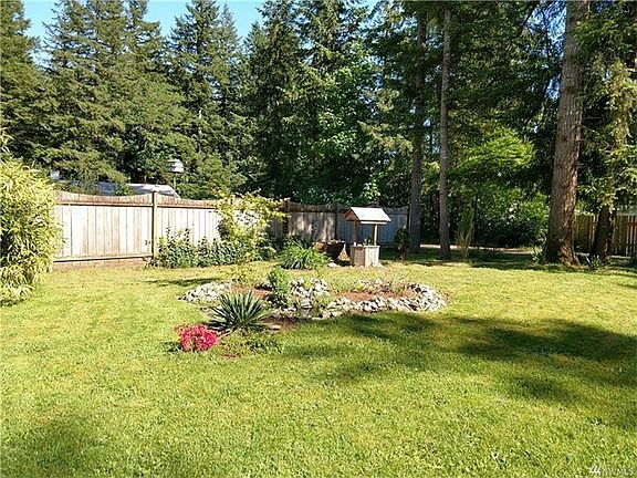 Across the lawn is a sweet pond and flower bed.  Make a wish in the wishing well.