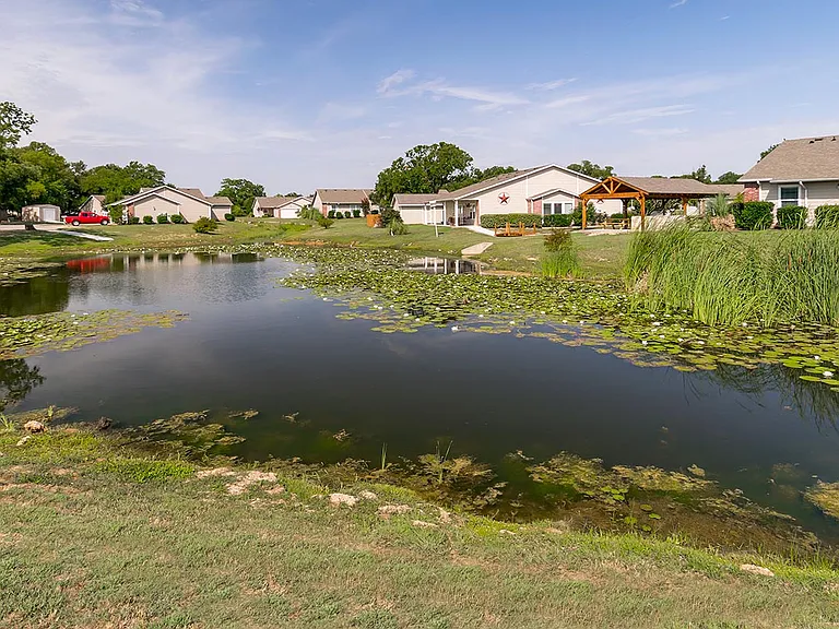 A pond winds it's way around the front of the property