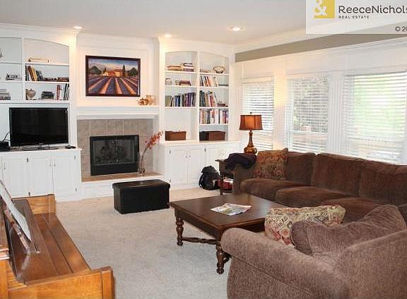 Large Open Living Room Features Tons Of Windows, Gas Fireplace,