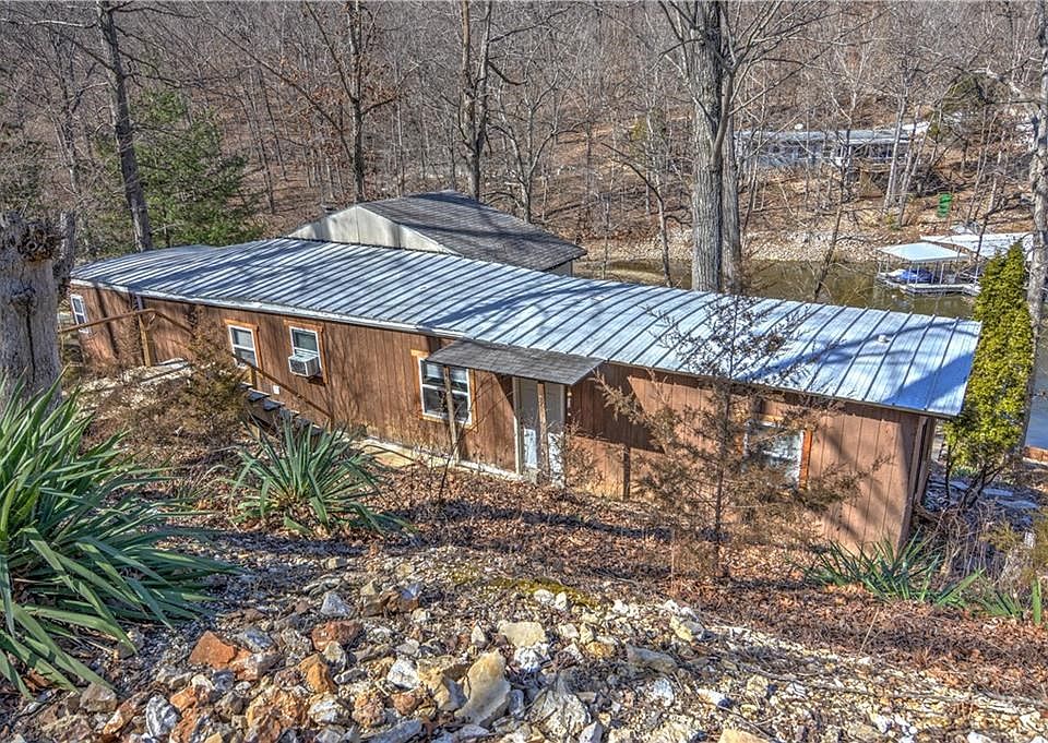 This property consists of a single-wide mobile home supplemented with an addition on the back side and a shed for storage.