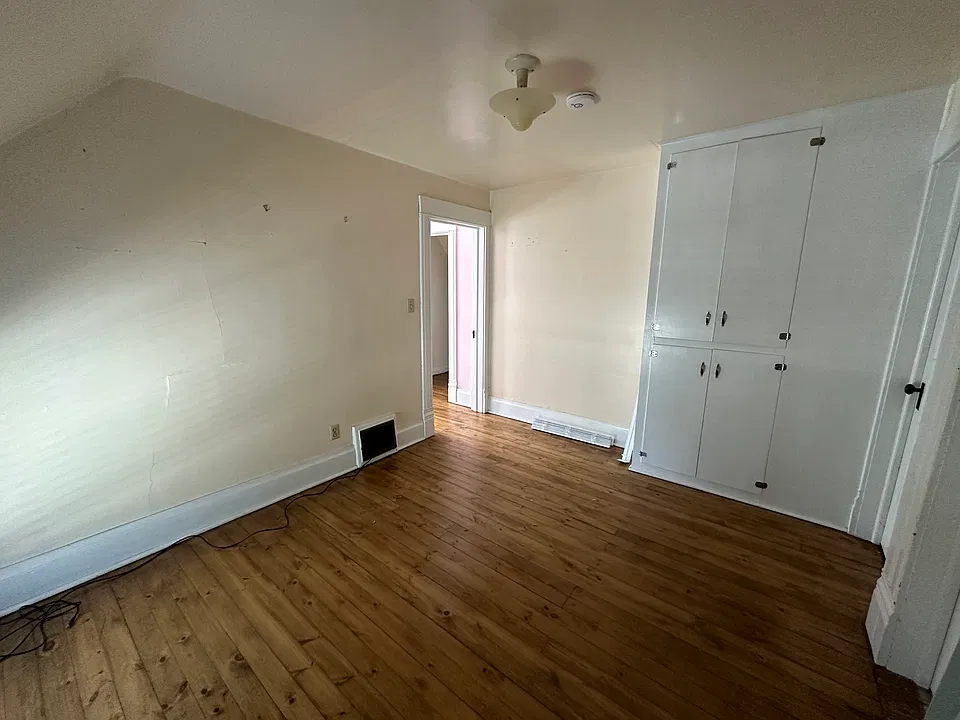 Second bedroom with built-in storage cabinets.