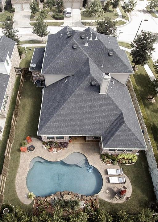 Gorgeous Home with Sparkling Salt Water Pool and Covered back patio with outdoor kitchen on Spacious  Corner Lot with Beautiful Landscaping and plenty of side yard left to enjoy!