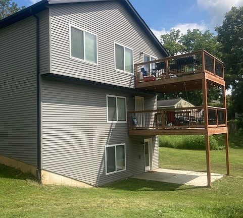Two decks and walk out patio in the back