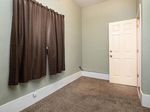 Bedroom with large window and spacious reach in closet.