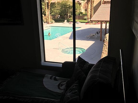 View of south pool from comfy Chaise in Guest Bedroom