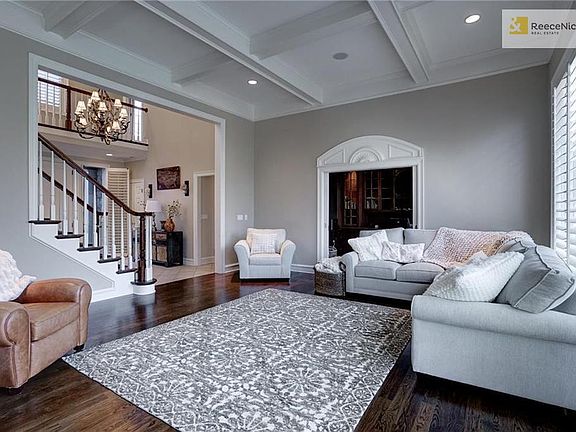 Formal living room with high ceilings  open to office/library