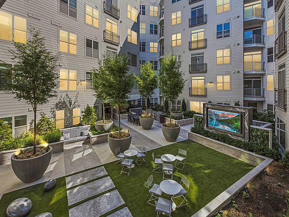 Courtyard with ample seating, green space and TV