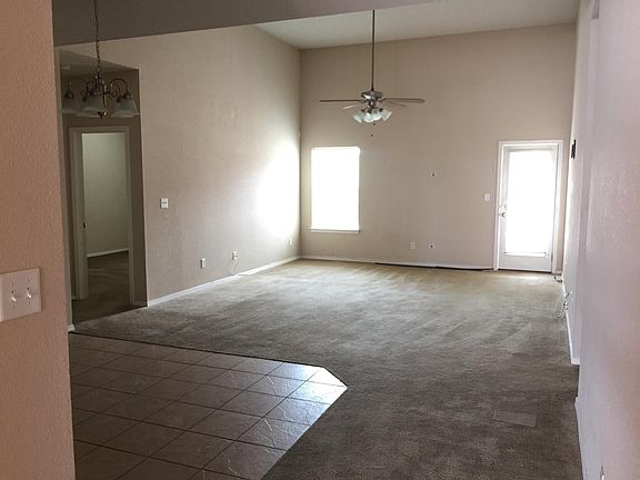 entry, dining area(tile), living area(carpet), master bedroom through door on left