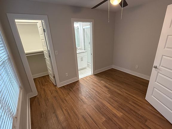 Private First-Floor Bedroom: Spacious suite with hardwood floors, private bath, and walk-in closet.