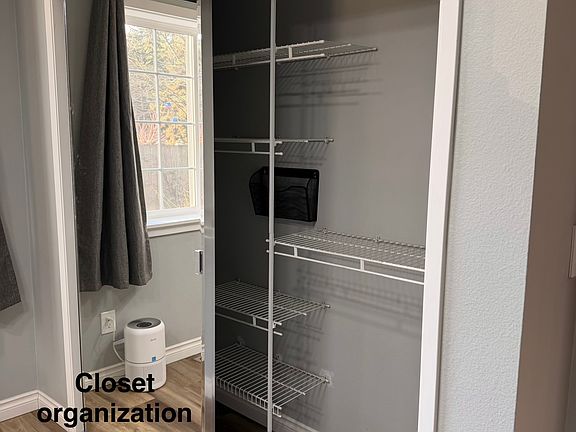 Southeast bedroom closet, with mirror door. Closet shelving system has been removed and a new, nicer organization system is being installed.