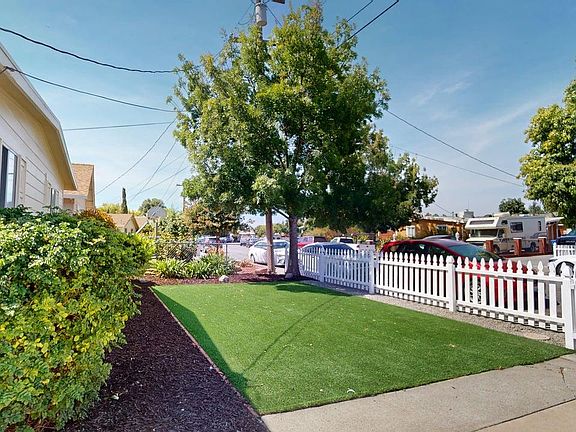 Front yard with artificial grass and fence