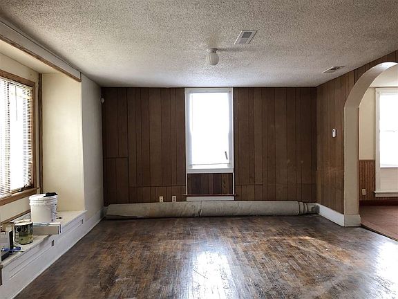 Living room looking towards South.  There is a seating area in the large front East facing windows. Seller is still working on making property nicer.  Will consider renting, renting to own for this property.