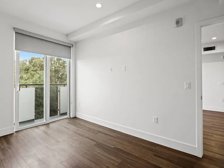 Bedroom with Recessed Lighting, Vinyl Flooring, and Balcony