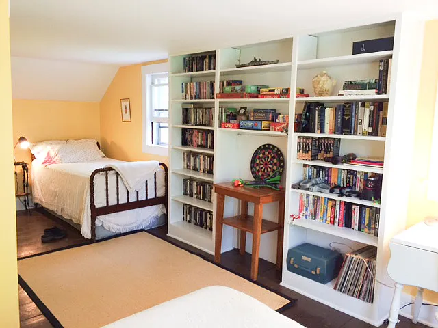 Upstairs bedroom has lots of built in shelves and loads of character.