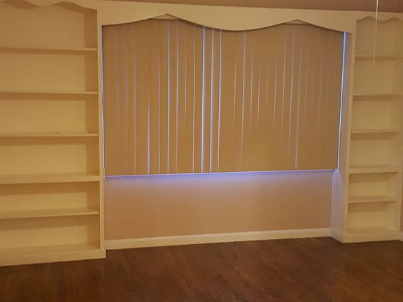 Living room has built in book shelves