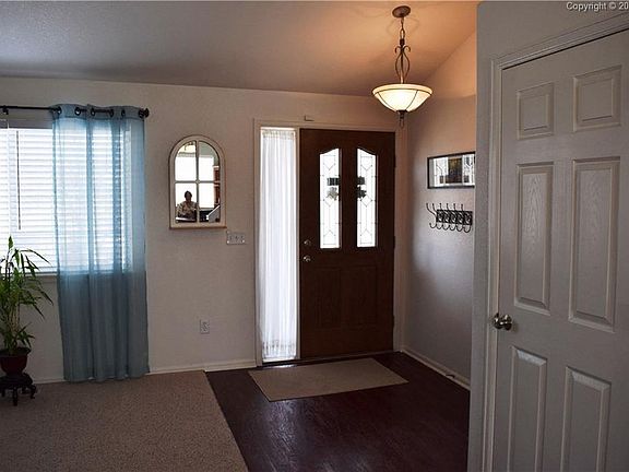 Custom Front Door with side-lite, updated flooring, and coat closet.
